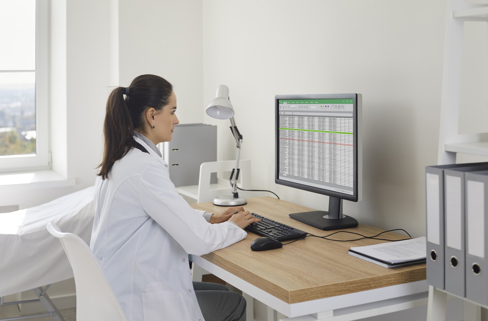 Provider reviewing a billing spreadsheet at a desk