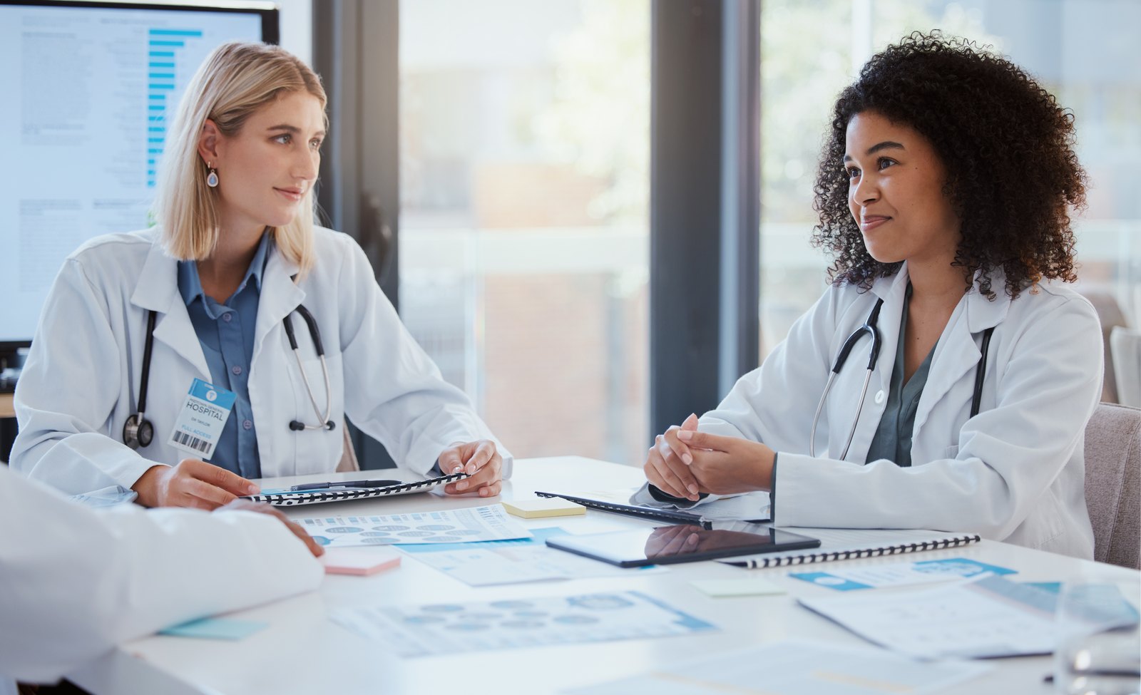 Two practice leaders reviewing reports together at a table