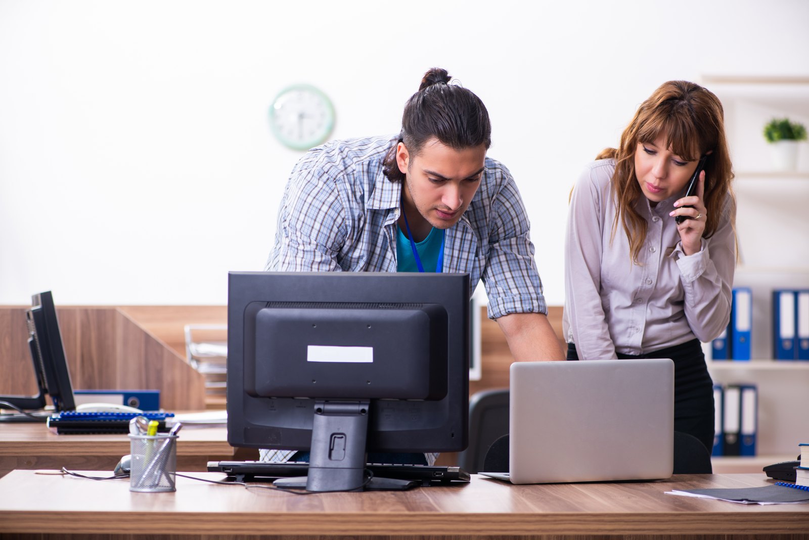 IT specialist helping a staff member at her desk